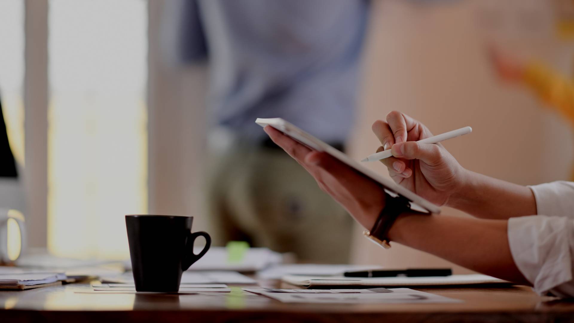 Man sitting at his desk using his iPad.